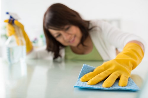Trained staff using PPE while cleaning carpets